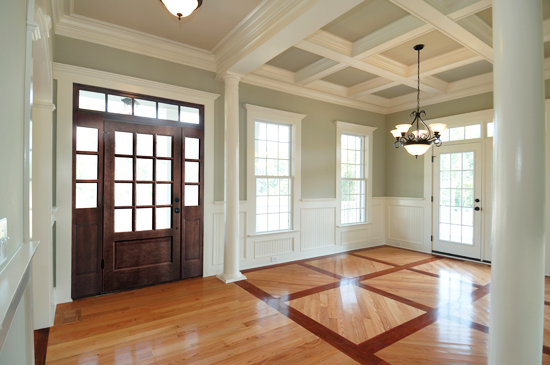 For a large space like this, having many architectural elements going on feels appropriate, while for a smaller space, a simpler treatment, such as just wainscoting, would work well.