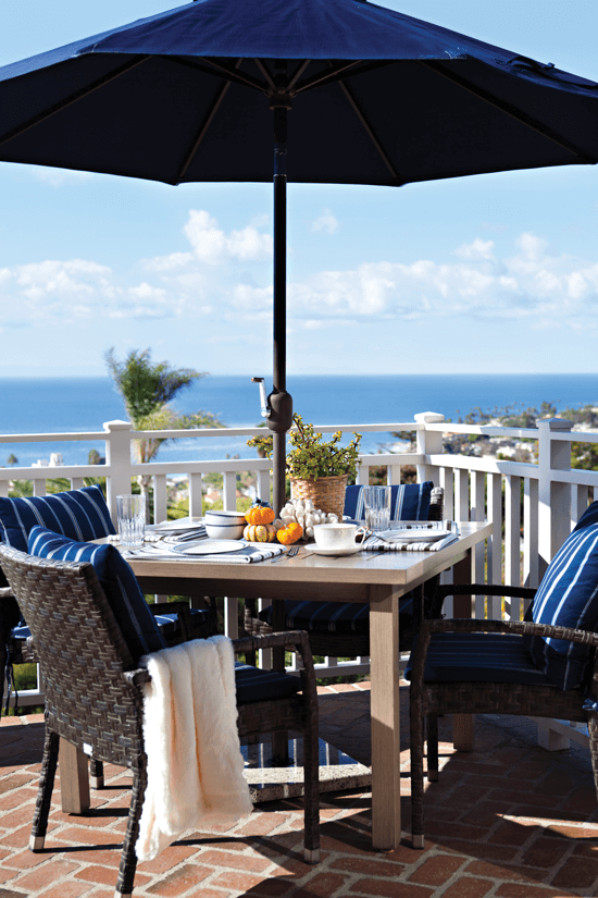 The navy motif from the interior carries through to the patio in the umbrella and patterned chairs.