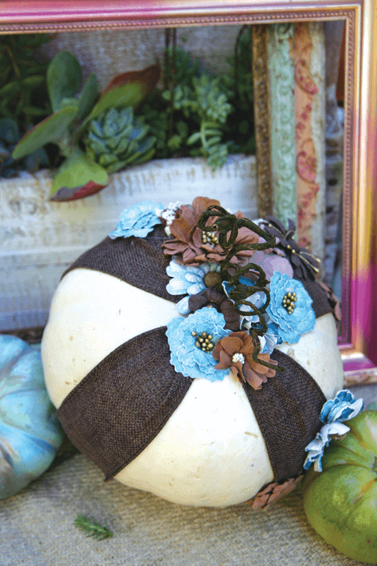 Wrapped in ribbon and fabric flowers, this pumpkin is transformed into a freestanding ornament.