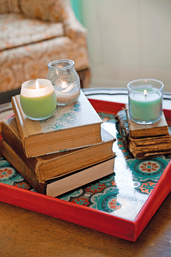 Use a small book collection to add height and framing to other collectibles, such as picture frames, vintage toys or antique stationery and writing implements.