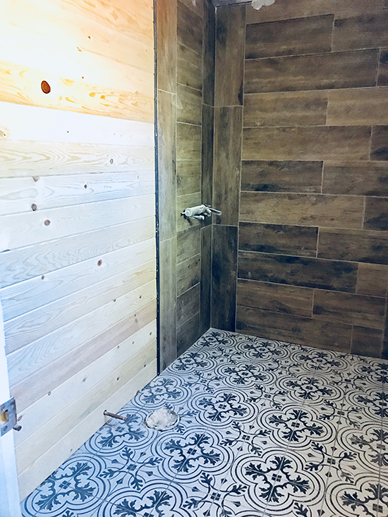 Porcelain tile was selected for the floor, which will stand up well to high foot traffic. It also complements the barn wood wall tile in the shower.