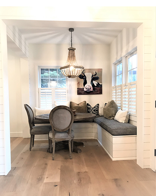 updated dining space with beautiful banquette seating and rustic touches