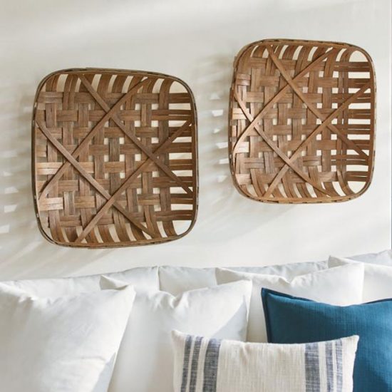 Two woven tobacco baskets hung above couch.