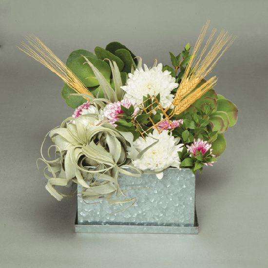 Add non-floral items to an arrangement for a centerpiece that breaks the mold in a beautiful way.