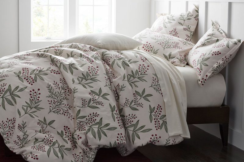 Plush winter-themed bedding with berries and leaves for a cozy Christmas Eve