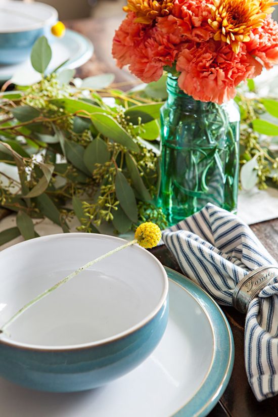 Bold colors mixed with muted colors come together nicely to create a warm and inviting fall Thanksgiving table.