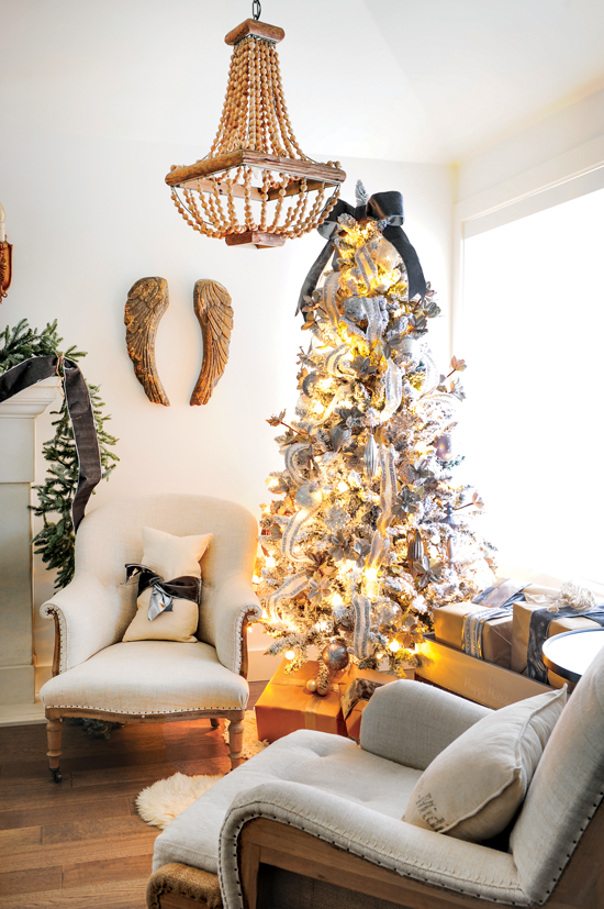 Sitting area with a pair of arm chairs and a beautiful pre-lit Christmas tree give this space a warm and cozy feel. // Cottages & Bungalows