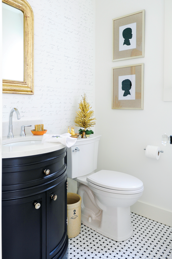 Bathroom accent wall created using a script stencil, with accents of green and gold to tie in with the winter theme.