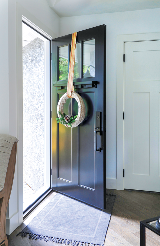 Front door with DIY wreath created from Styrofoam and and old sweater. // Cottages & Bungalows