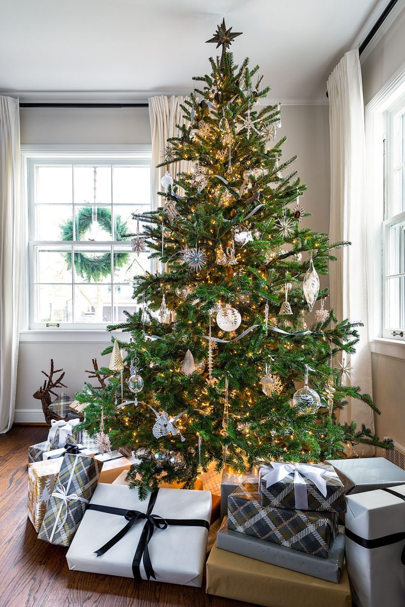 A cottage Christmas tree with presents underneath