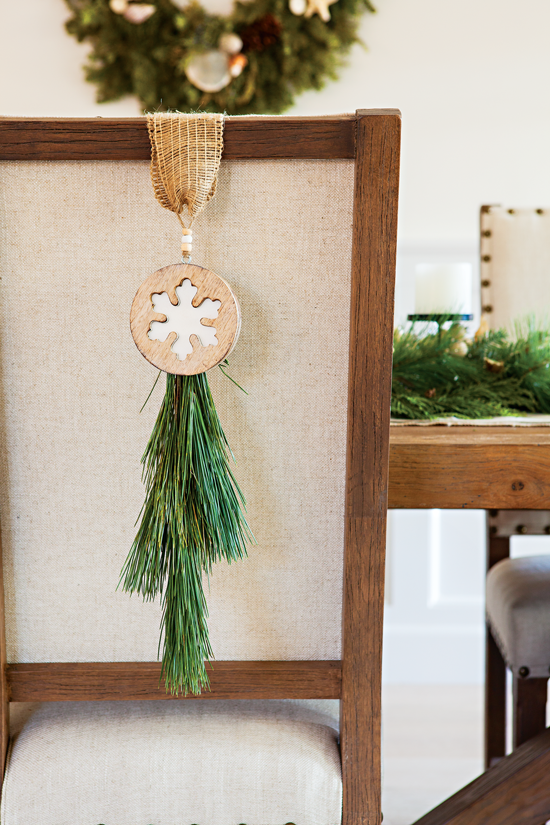 Dining room chair with snowflake accent and greenery. // Cottages & Bungalows