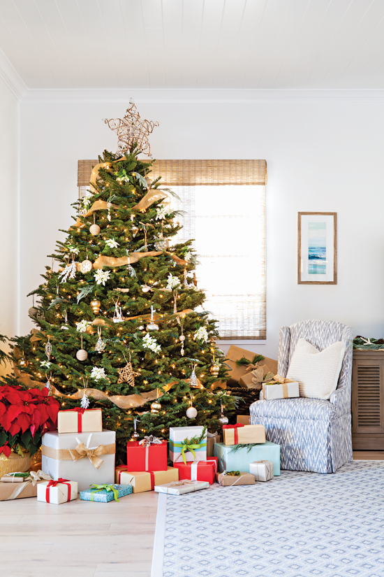 A large Christmas tree serves as the focal point of the living area in this modern beach cottage.