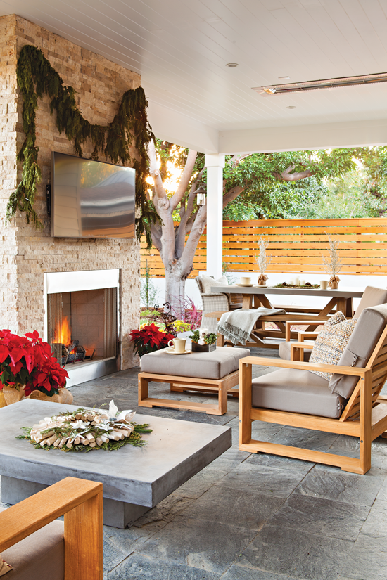 Outdoor sitting area with fireplace and Christmas décor. // Cottages & Bungalows