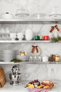 Open kitchen shelving with gray marble backing