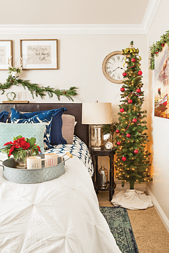 The red and green pieces of Christmas décor in this bedroom are accented with blue to give a lively and intriguing look. // Cottages & Bungalows