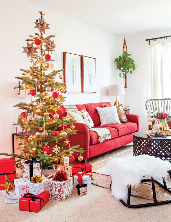 A peaceful living room marked by simplicity comes alive for the holidays, complete with a classic tree, gifts galore and a faux fur pelt.