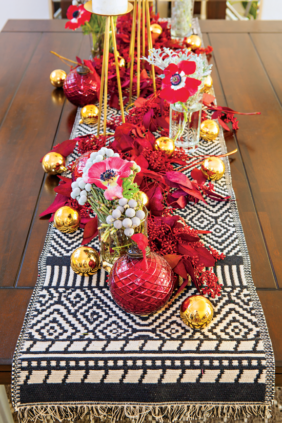 A tribal textile brings in the bohemian edge while red dyed eucalyptus and red cosmos add an artsy element.