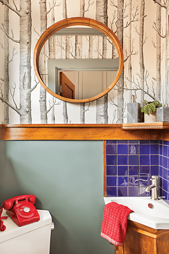 Small bathroom with birch tree wallpaper.