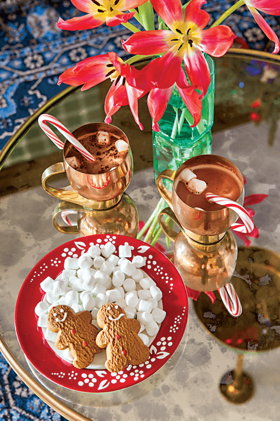 Tabletop display of hot chocolate, marshmallows and gingerbread cookies.