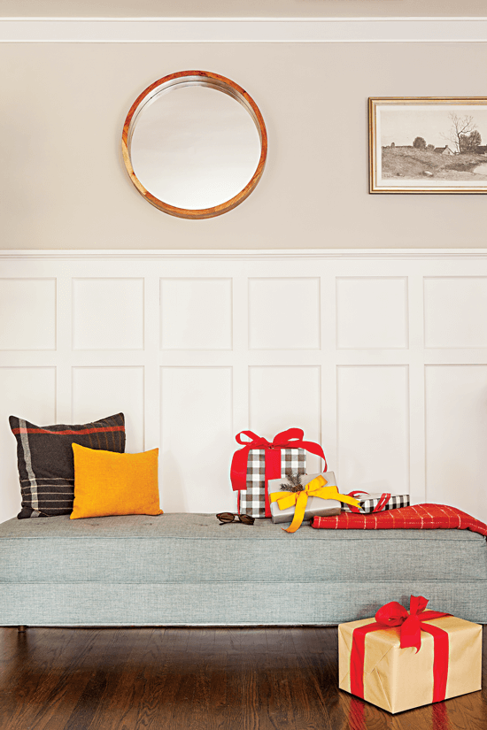 Gray upholstered bench with accent pillows