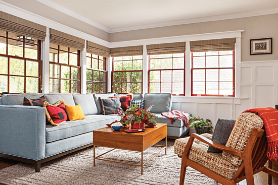 Living area with blue sectional couch and accent chair.