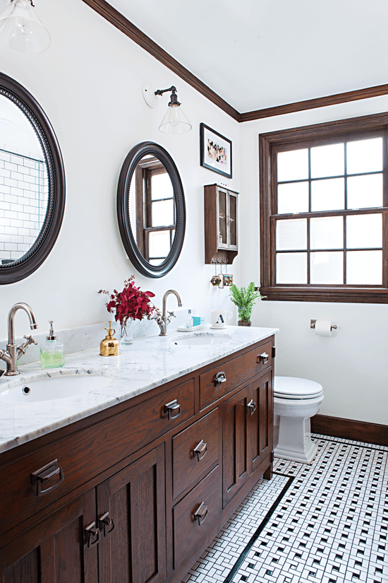 Remodeled bathroom with light counters and dark cabinets.