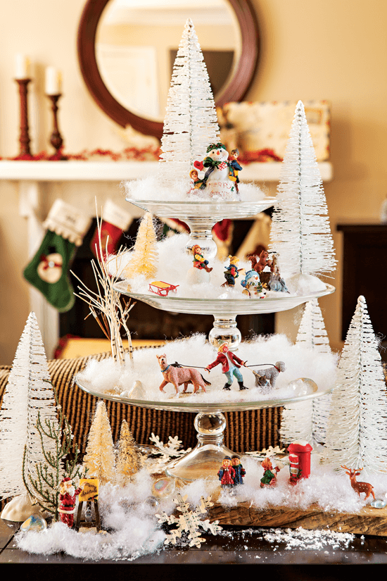 Pedestal plates stacked atop each other create a striking decorative focal point when transformed into a miniature wintry village