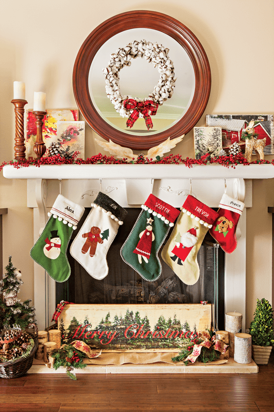 A cotton ball wreath coupled with a festive ribbon creates a rustic-cottage focal point for the mantel. Stockings are hung from the mantel and a "Merry Christmas" sign is displayed below.