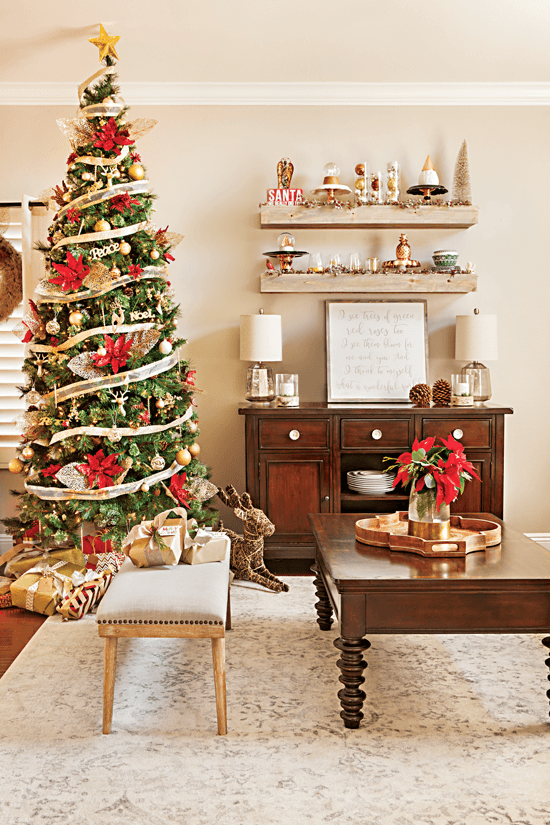 Living room area featuring an elegantly-decorated Christmas tree adorned with red and gold accents. // Cottages & Bungalows