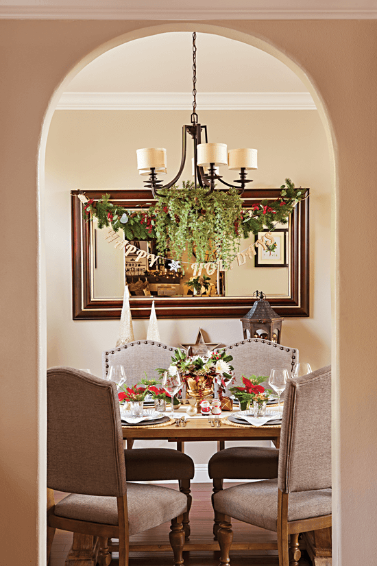 An elegant Christmas dinging area shown through an arched entryway. // Cottages & Bungalows