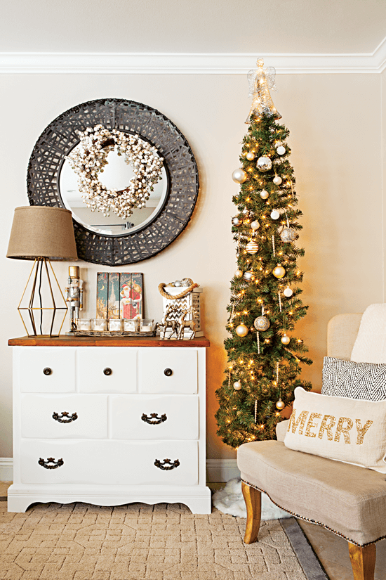 A skinny Christmas tree is used in this space to create dimension and visual interest—decorated with simple old white ornaments, it matches her refinished dresser. // Cottages & Bungalows