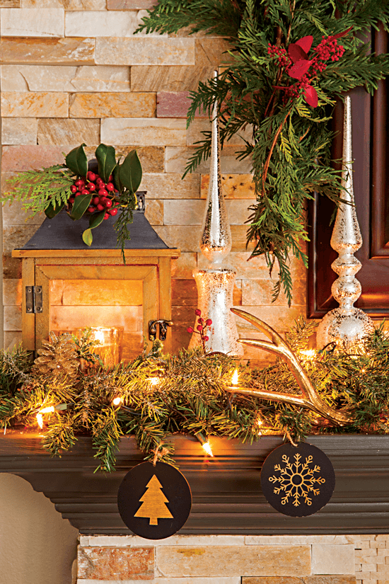 This fireplace mantel is decorated with simple greenery, deer antlers and wood ornaments, giving it a warm and rustic feel. // Cottages & Bungalows