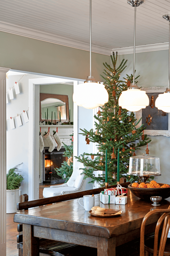 The informal dining room provides a space where friends and family can gather on the family heirloom bench and enjoy the gingerbread-decorated Christmas tree in the corner.