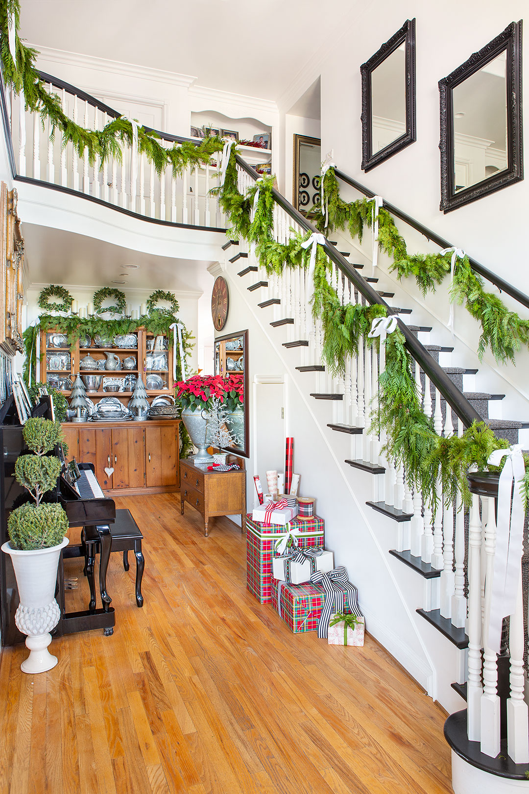 Long, garlands of real holiday greenery line the stairway of Janice Morrow's house.