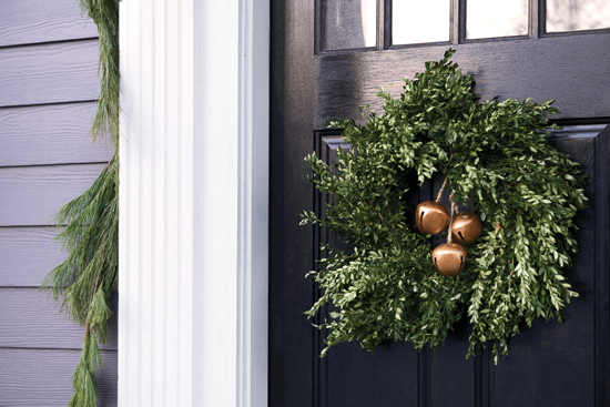 The dark front door of this home allows the green wreath to pop.