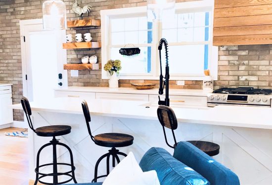 A combination of open shelving and enclosed cabinets give the kitchen a boost of rustic style.