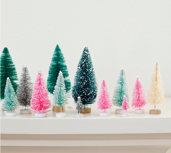 Rainbow bottlebrush Christmas trees in an array of colors and sizes.