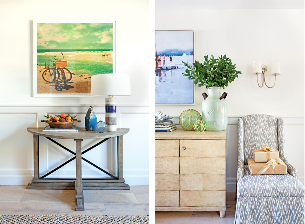 Large coastal wall-hangings, a hallway table and accent chair make up the entryway details of this modern beach cottage.