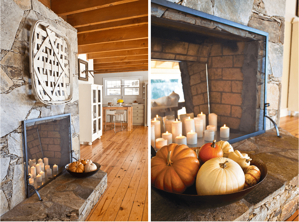 stone fireplace decorated for fall with pumpkins, candles and a tobacco basket