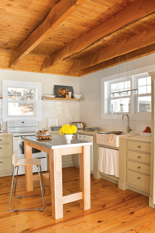 By removing the upper cabinets from the kitchen, the Blehms created an open space where they placed flat shelving to display pottery and artwork.