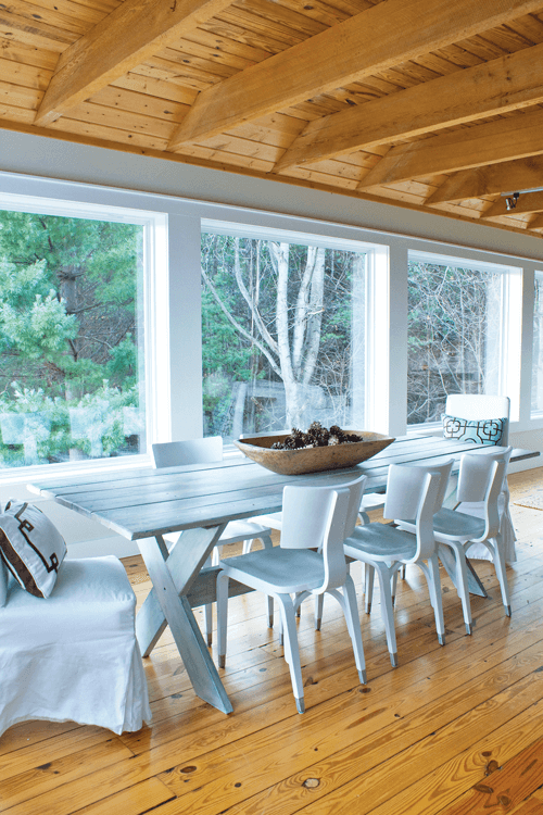 Formerly a picnic table, Angela cleaned and repainted it to capture the cozy vibe in the dining room which is underscored by the gorgeous views beyond the floor-to-ceiling windows.