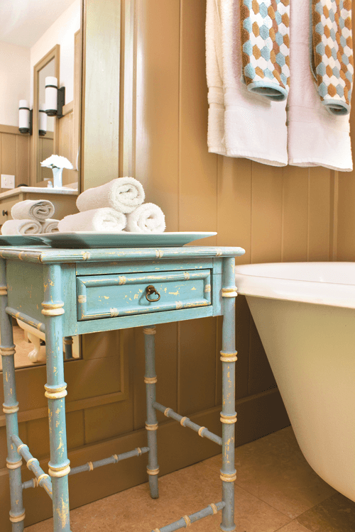 this vintage table was given a fresh coat of paint making it a great addition to the bathroom