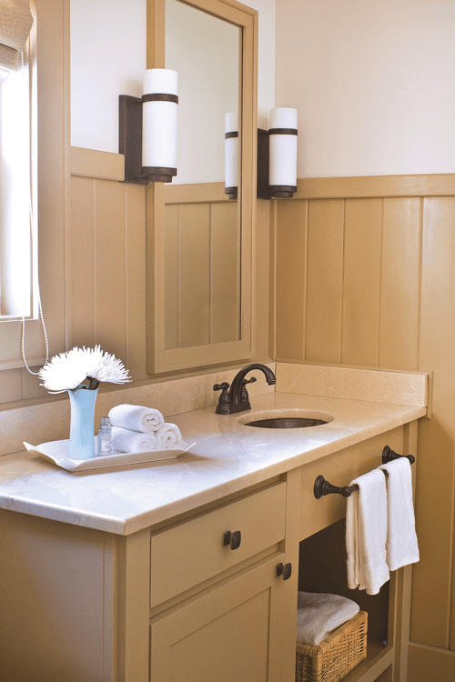 The team created the bathroom cabinets from the upper cabinet that were removed from the kitchen.