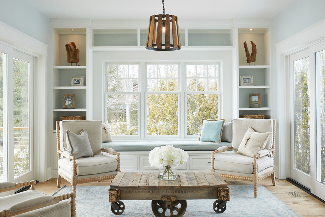 Lake cottage sitting room with pale blue and open shelves