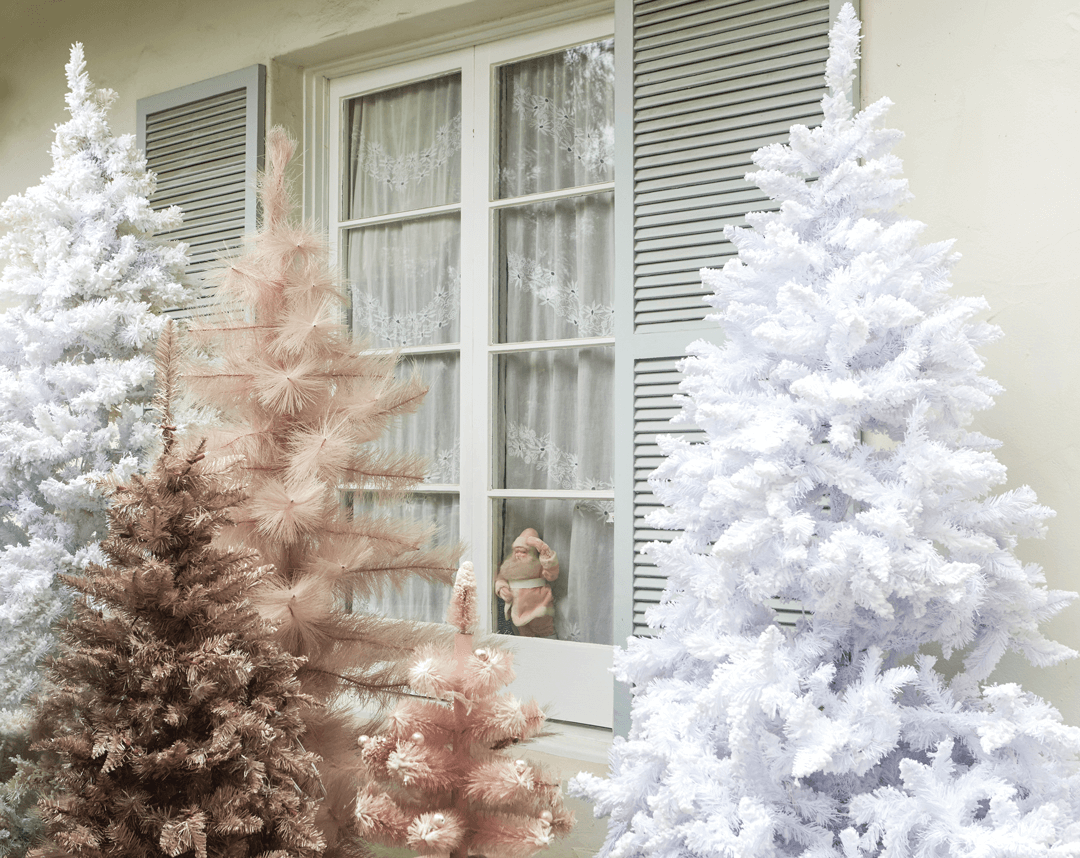 A forest of pink and white vintage style christmas trees makes a stunning sight outside. 
