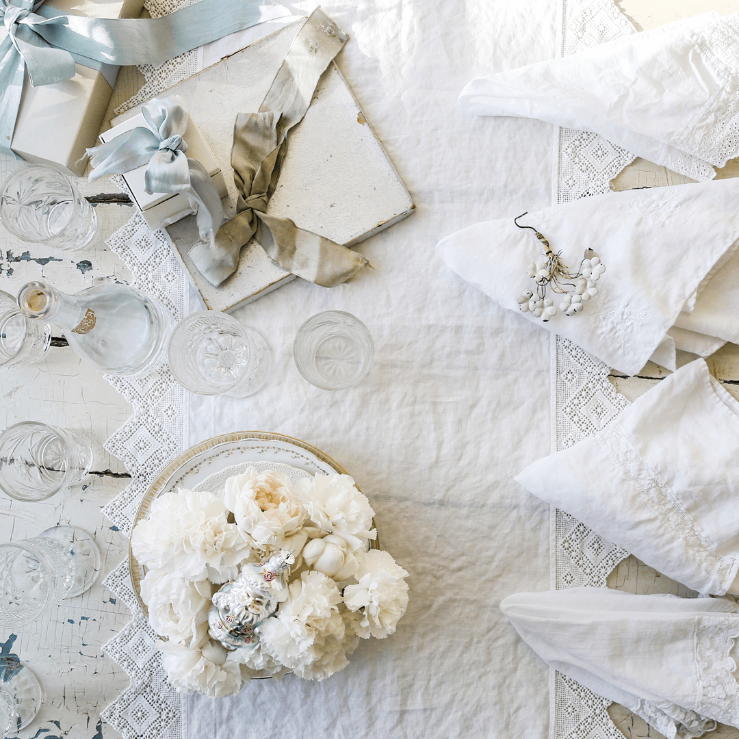 White antique Shabby Chic linens with blue and gray silk ribbons. 