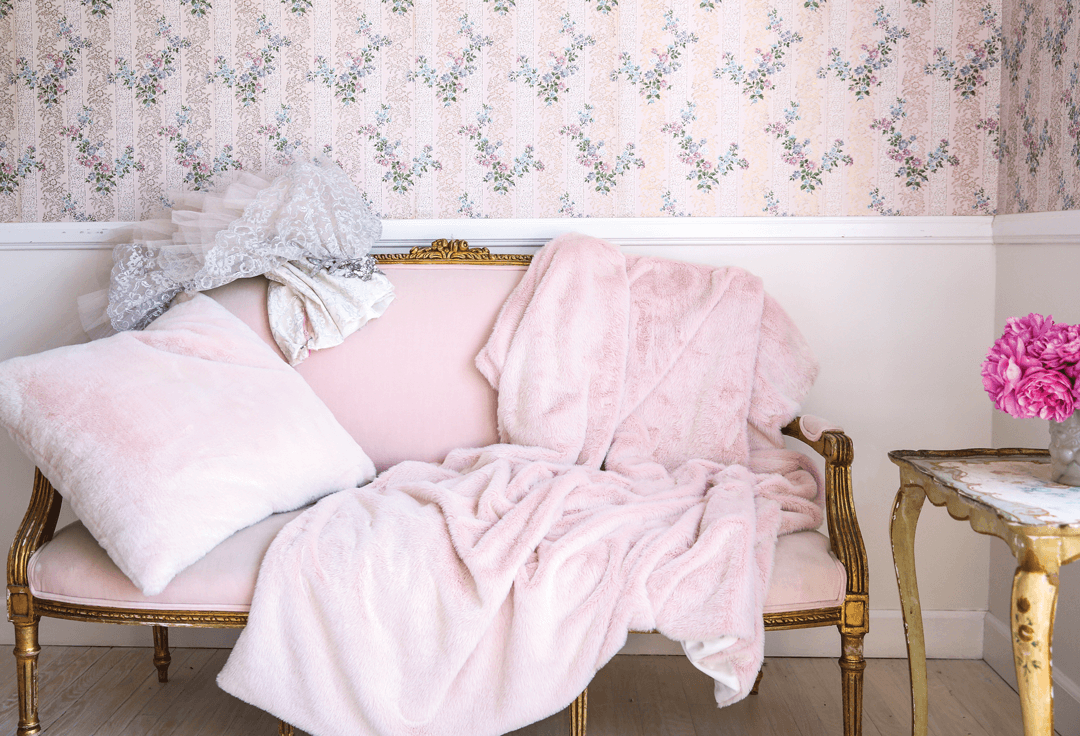 Pink antique wallpaper, pink upholstery on the settee and pink textiles are essential to Shabby Chic christmas decor