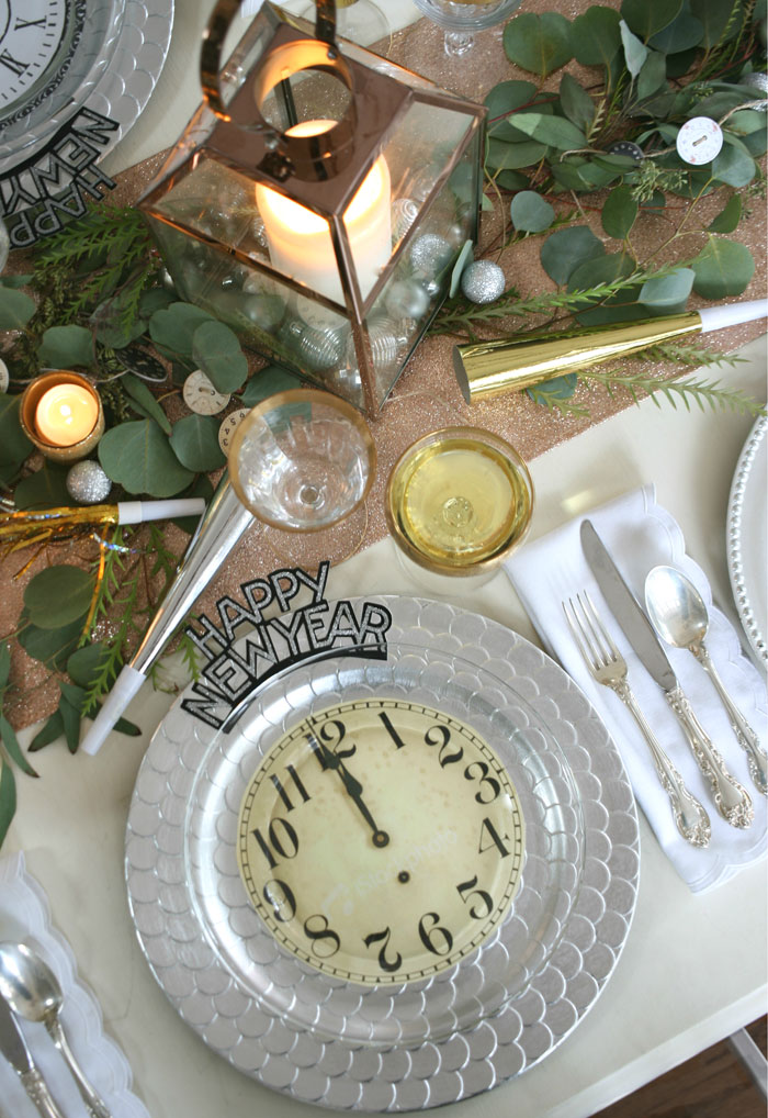 5853 Setting a table with a mix of our favorite metals, includes gold rimmed champagne glasses, silver chargers, copper lanterns and a glittery rose gold table runner. These fun clock plates are a cinch to make!