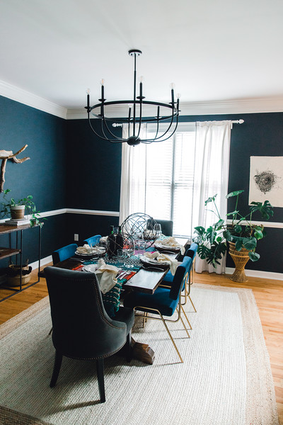 Navy dining room with natural and vintage-inspired design featuring the Rylann chandelier from Capital Lighting.