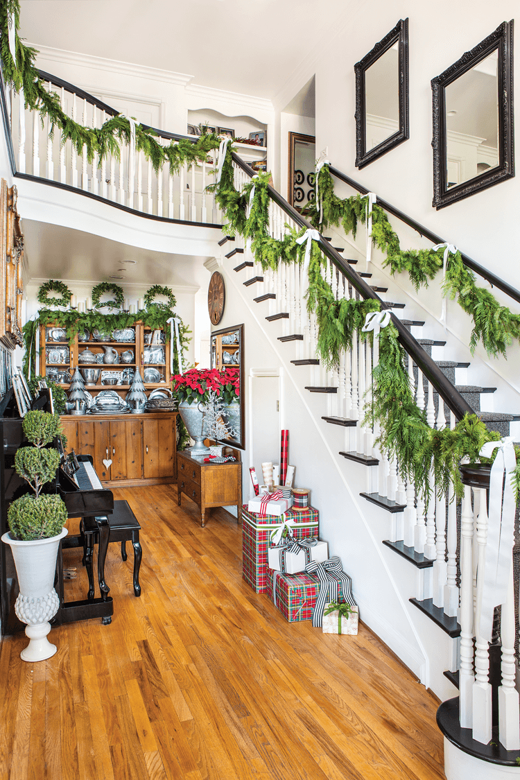 JANICE AND HER FAMILY DECK THE HALLS with fresh cedar every November through Christmas. Two weeks before the holiday, they will take down these boughs and put up new ones, renewing the fresh winter scent.